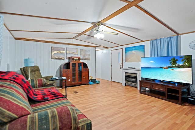 living room featuring wood-type flooring, vaulted ceiling, ceiling fan, and wood walls