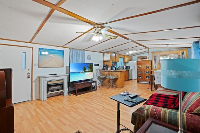 living room featuring ceiling fan, lofted ceiling, and light hardwood / wood-style flooring