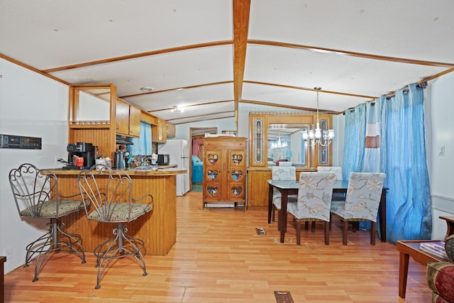 kitchen featuring lofted ceiling with beams, white refrigerator, light hardwood / wood-style flooring, a notable chandelier, and kitchen peninsula