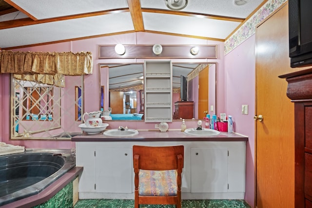 bathroom with a bathing tub, a textured ceiling, vanity, and lofted ceiling