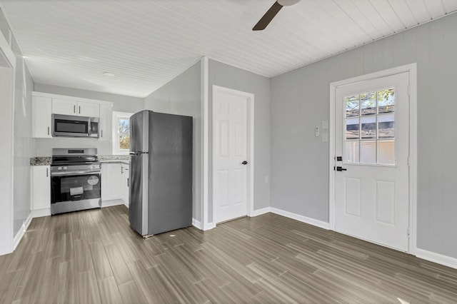 kitchen with white cabinetry, hardwood / wood-style floors, ceiling fan, and appliances with stainless steel finishes