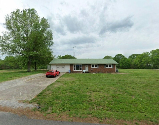 ranch-style house featuring a garage and a front lawn