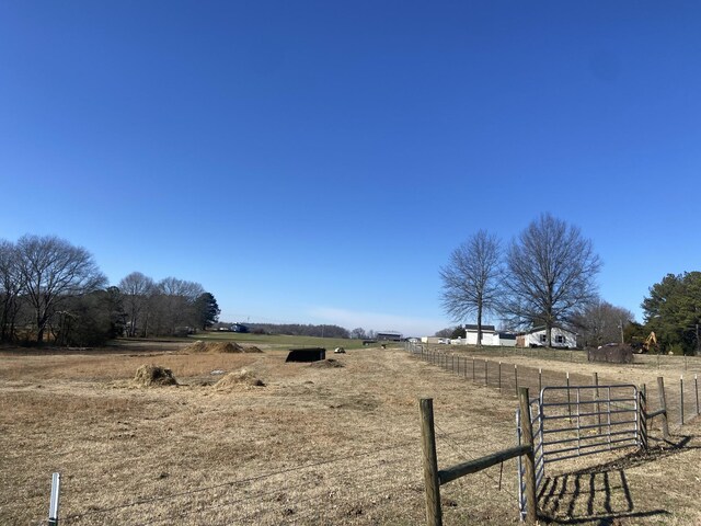 view of yard featuring a rural view and fence