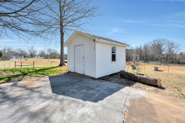 view of shed featuring fence