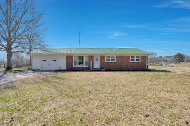 ranch-style house featuring metal roof, a garage, brick siding, concrete driveway, and a front lawn