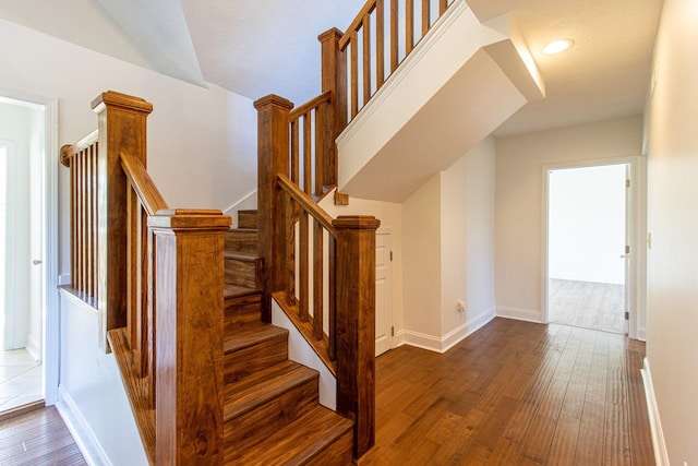 stairway featuring hardwood / wood-style flooring