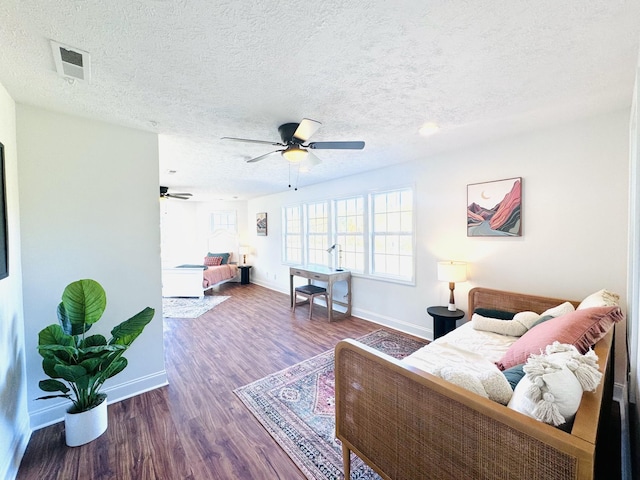 living room with ceiling fan, dark hardwood / wood-style flooring, and a textured ceiling