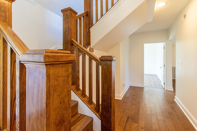 stairs featuring hardwood / wood-style flooring