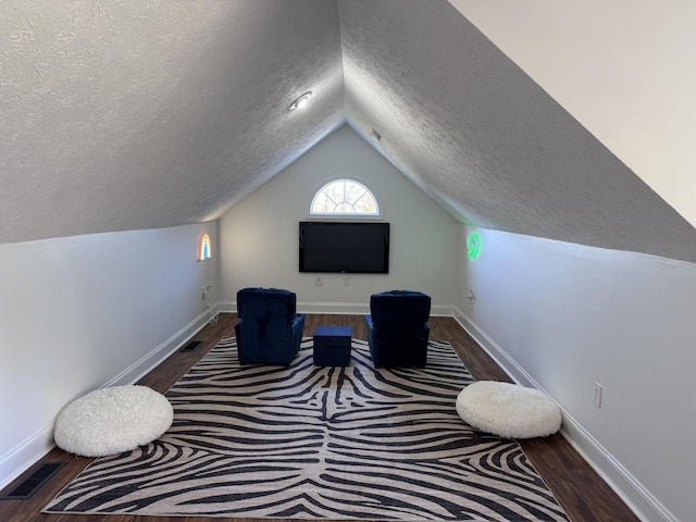 office area with a textured ceiling, dark hardwood / wood-style flooring, and vaulted ceiling