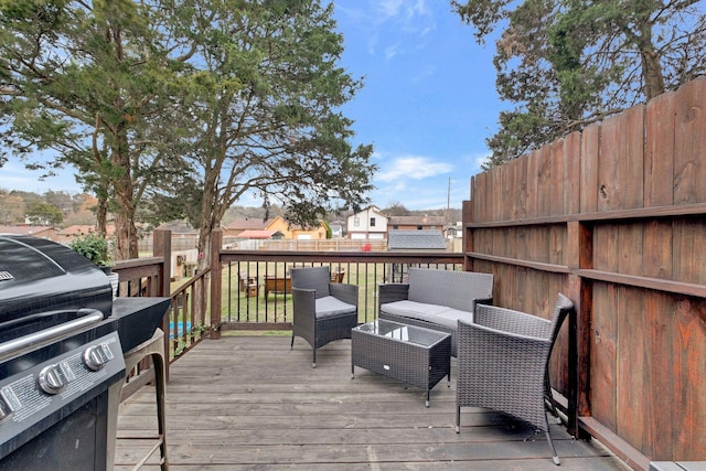 wooden terrace featuring area for grilling and an outdoor hangout area