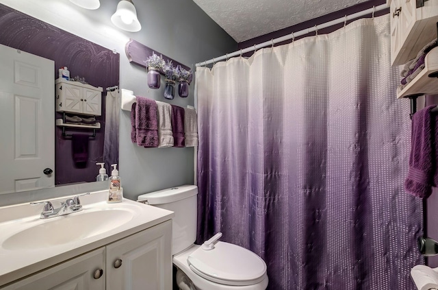 bathroom featuring vanity, toilet, and a textured ceiling