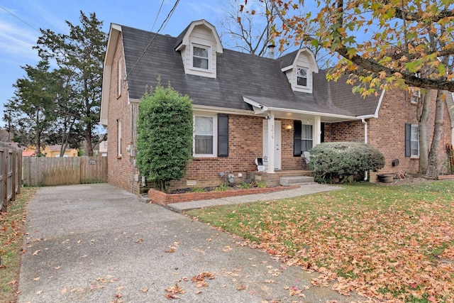 new england style home featuring a front yard