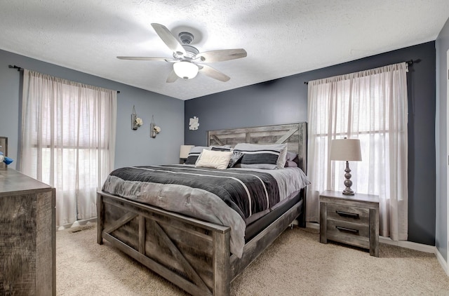 carpeted bedroom featuring a textured ceiling and ceiling fan