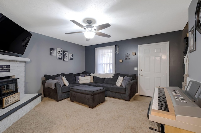 living room featuring a textured ceiling, light colored carpet, and ceiling fan