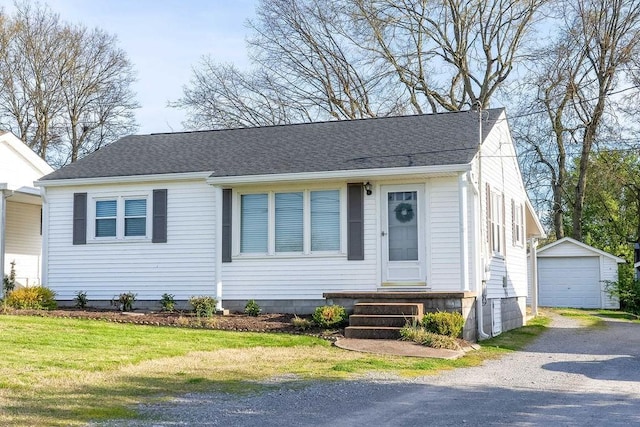 view of front of house featuring a garage and an outdoor structure