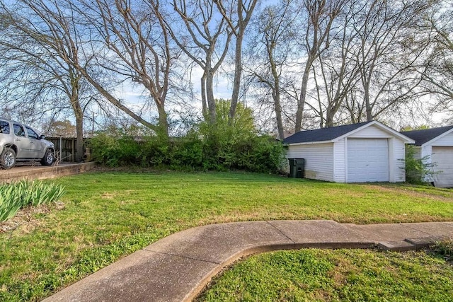 view of yard featuring a garage and an outdoor structure