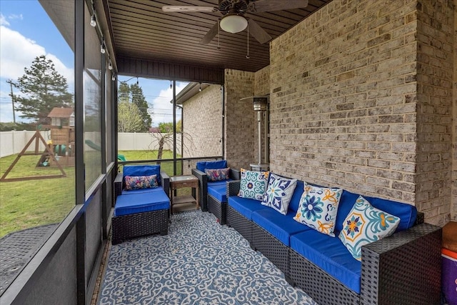 sunroom featuring ceiling fan