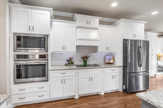 kitchen featuring custom range hood, appliances with stainless steel finishes, tasteful backsplash, dark hardwood / wood-style flooring, and white cabinetry