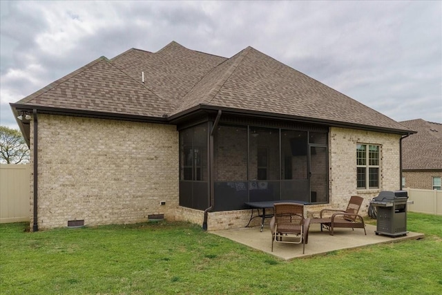 rear view of property featuring a sunroom, a patio area, and a yard