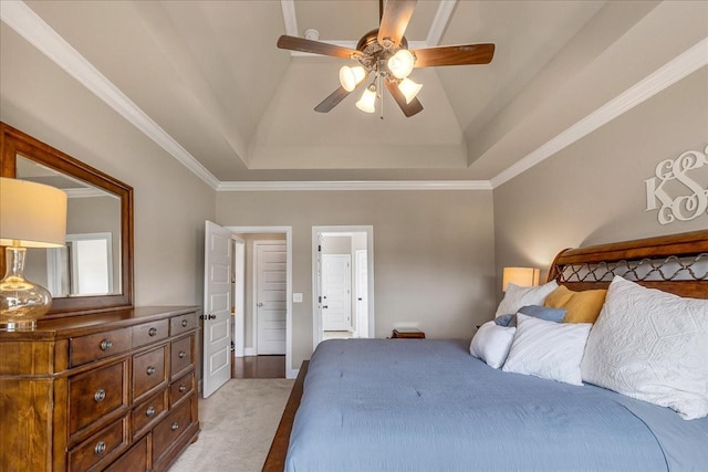 bedroom featuring light carpet, a raised ceiling, ceiling fan, and ornamental molding