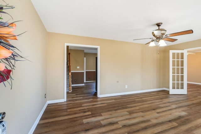 spare room featuring ceiling fan, dark hardwood / wood-style flooring, and french doors