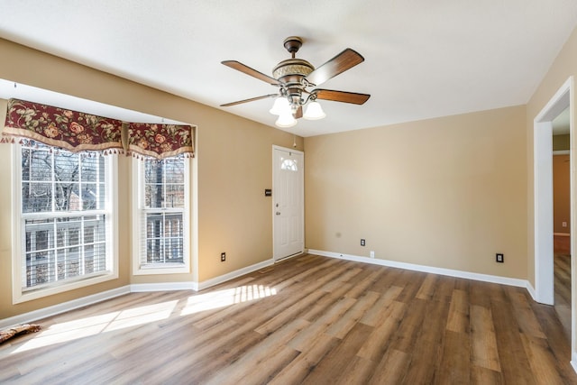 foyer entrance featuring wood-type flooring and ceiling fan