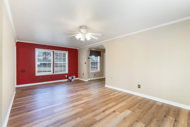 spare room featuring ceiling fan, ornamental molding, and light wood-type flooring