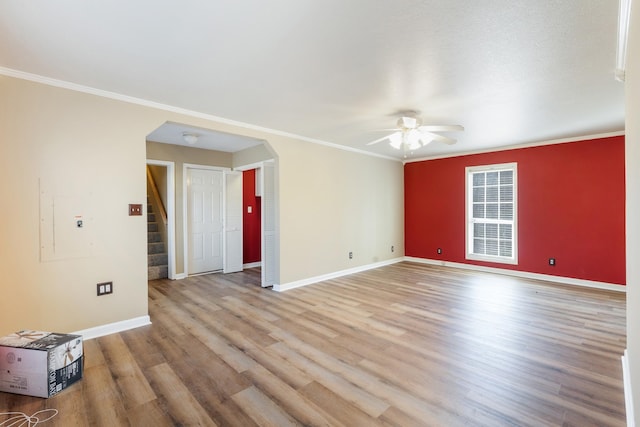 unfurnished room featuring crown molding, ceiling fan, and light hardwood / wood-style flooring