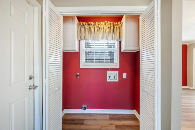 laundry area with cabinets, wood-type flooring, hookup for a washing machine, and electric dryer hookup