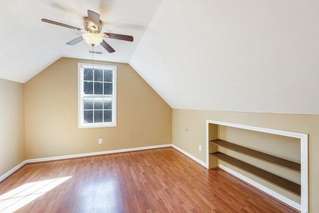 bonus room featuring light hardwood / wood-style flooring, ceiling fan, and vaulted ceiling