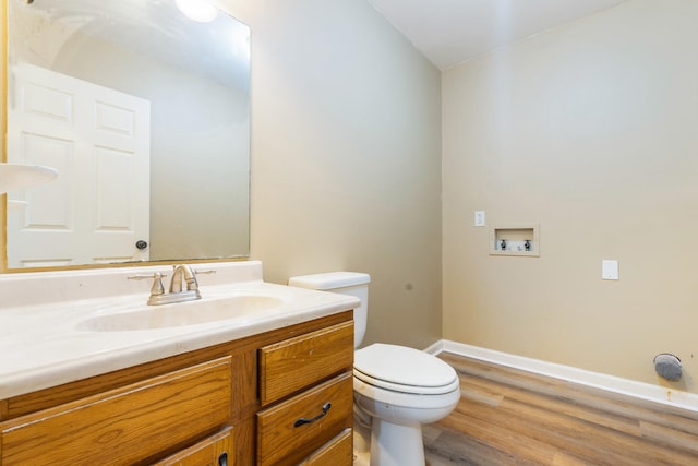 bathroom with vanity, wood-type flooring, and toilet