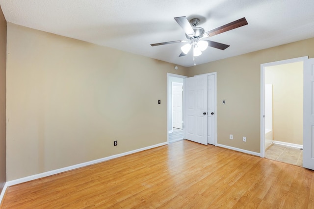 unfurnished bedroom featuring ceiling fan and light wood-type flooring