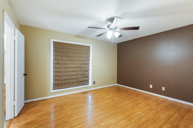 unfurnished room with ceiling fan and light wood-type flooring