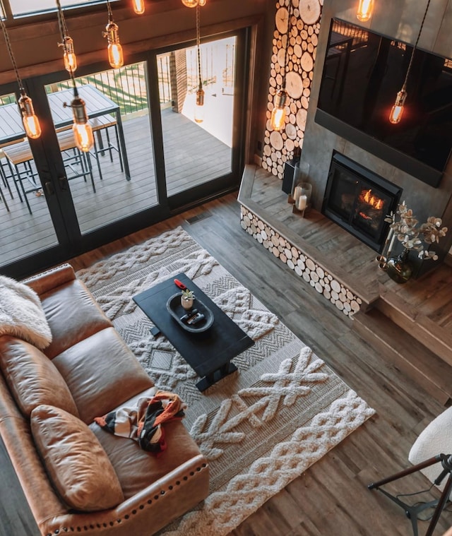 living room with dark hardwood / wood-style flooring and a tiled fireplace