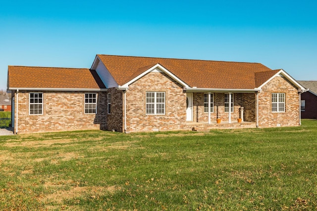 back of house with a lawn