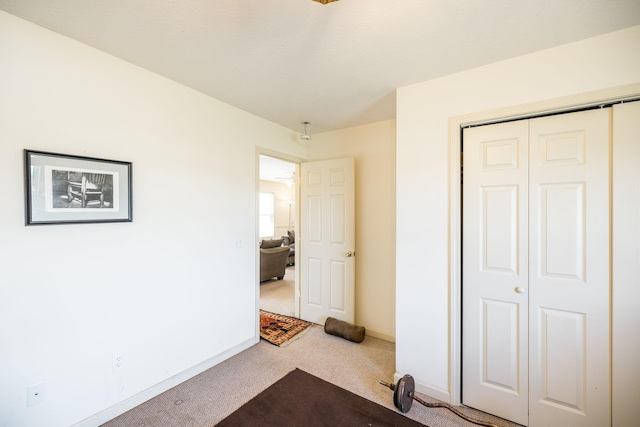 unfurnished bedroom featuring carpet and a closet