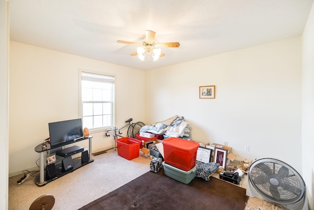 playroom featuring ceiling fan and carpet floors