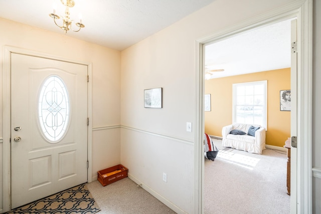 entrance foyer featuring carpet and a chandelier