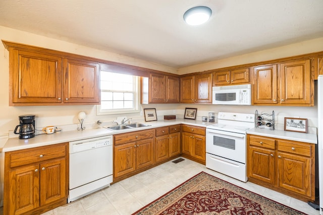 kitchen featuring sink and white appliances