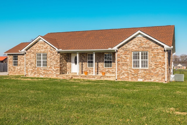 ranch-style house featuring central AC and a front lawn