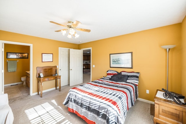 carpeted bedroom featuring ensuite bathroom and ceiling fan