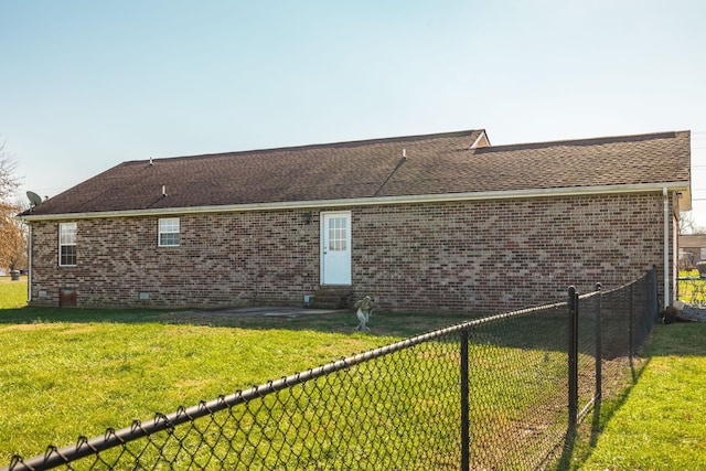 back of property featuring a lawn