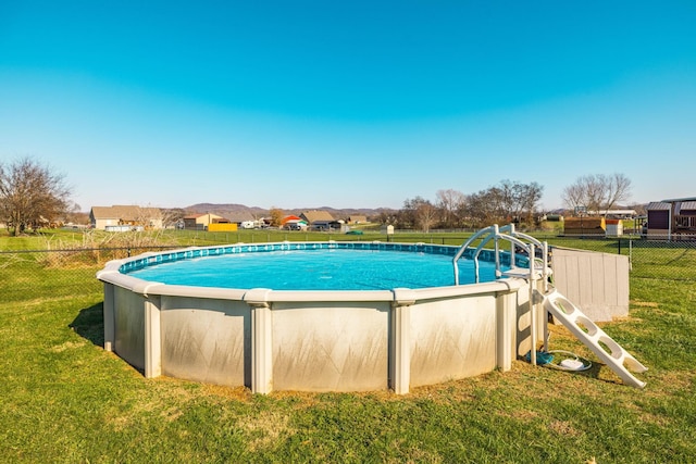 view of pool featuring a yard