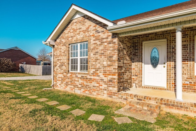 entrance to property with a lawn