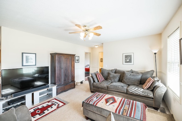 carpeted living room with ceiling fan