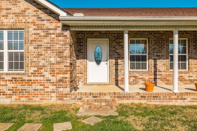 view of exterior entry with covered porch