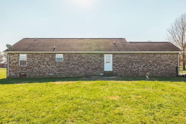 rear view of property with a lawn