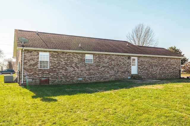 rear view of property with a lawn