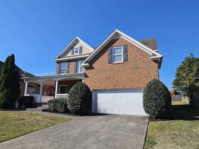 view of front facade featuring a front lawn, covered porch, and a garage