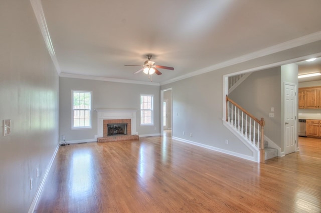 unfurnished living room with crown molding, ceiling fan, light hardwood / wood-style floors, and a brick fireplace